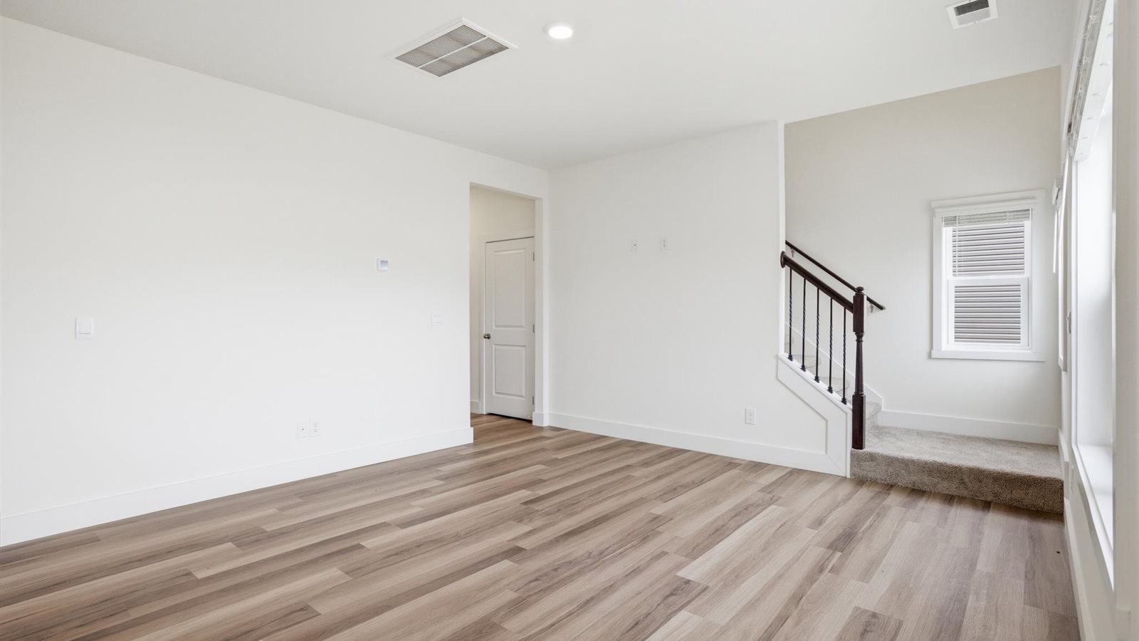 open living room area with luxury vinyl plank flooring