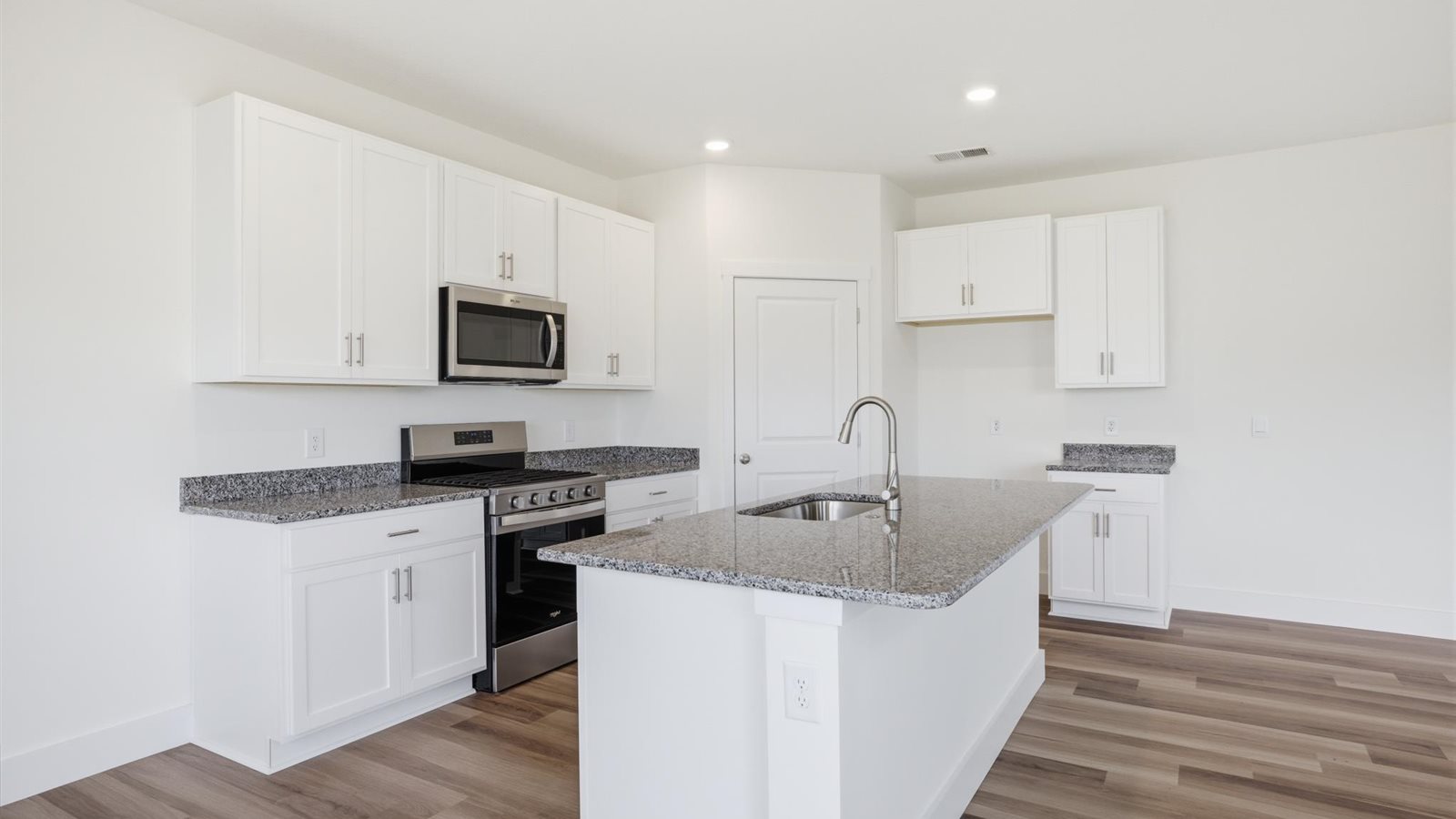 kitchen with granite countertops, island, and stainless-steel appliances