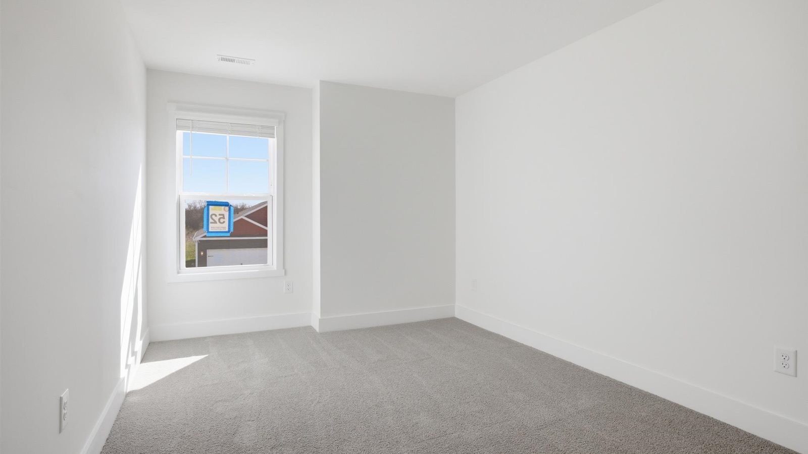 Bedroom with ample natural light and carpet floors