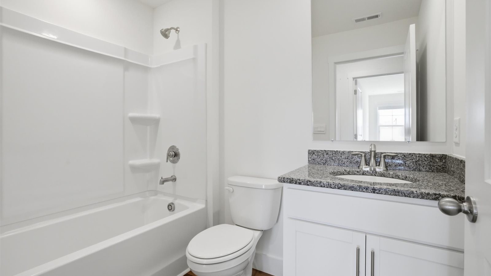 Guest bathroom with built in vanity and combination bathtub shower