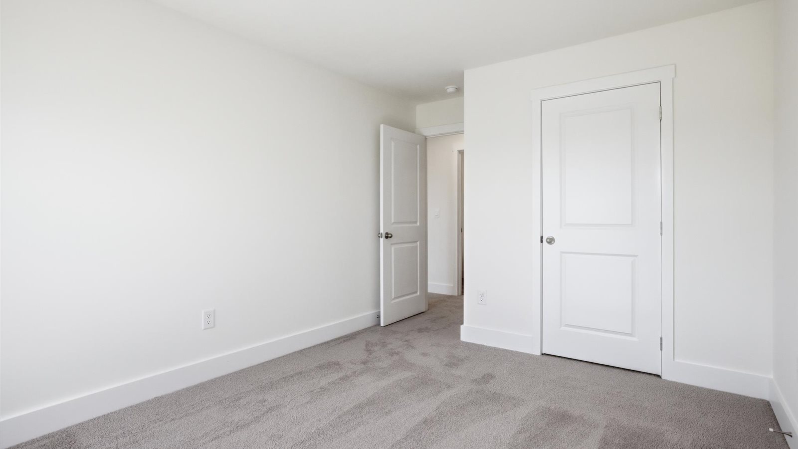 Bedroom with ample natural light and carpet floors