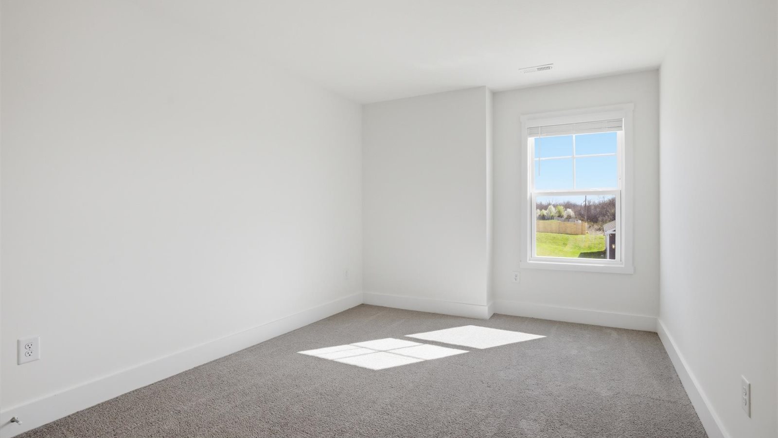 Bedroom with ample natural light and carpet floors