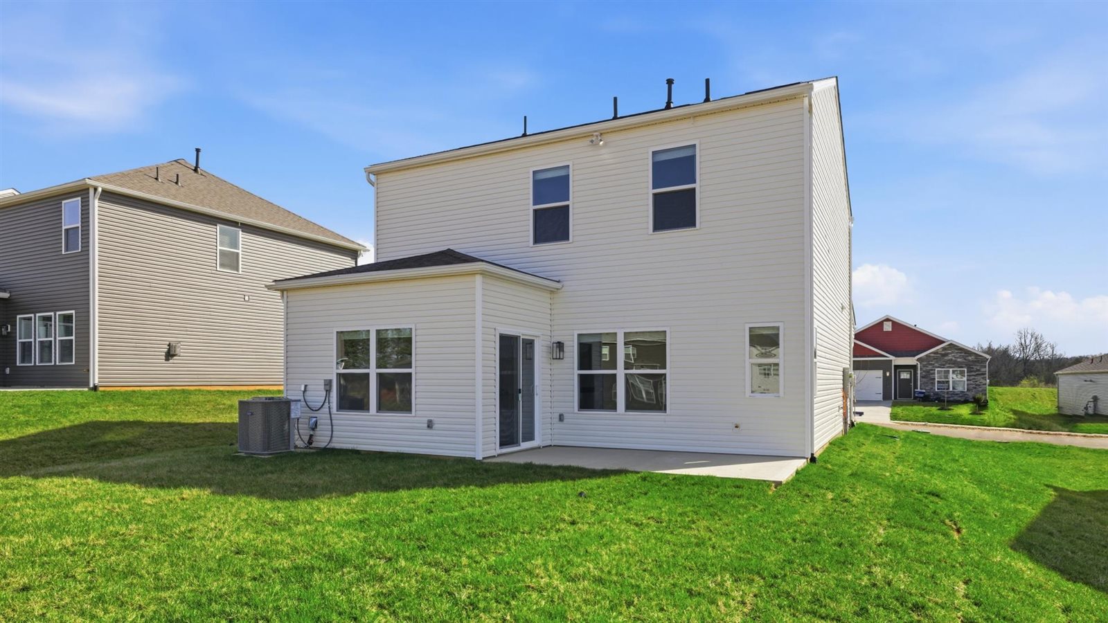 Rear exterior of home and landscaped sodded yard