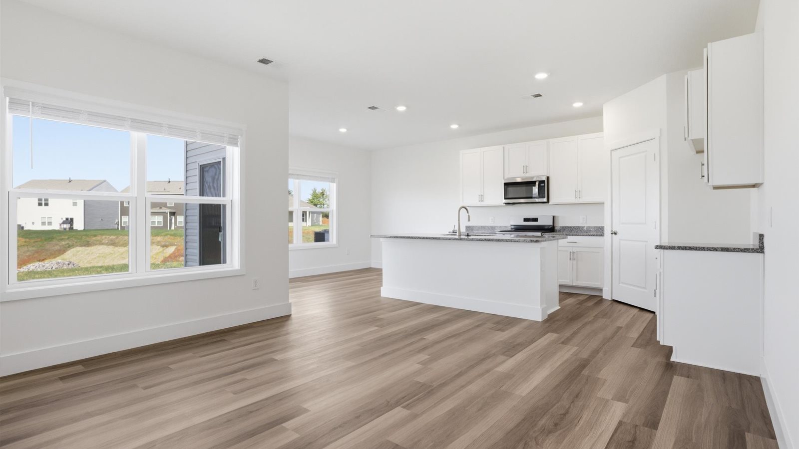 Open concept living, dining, and kitchen space