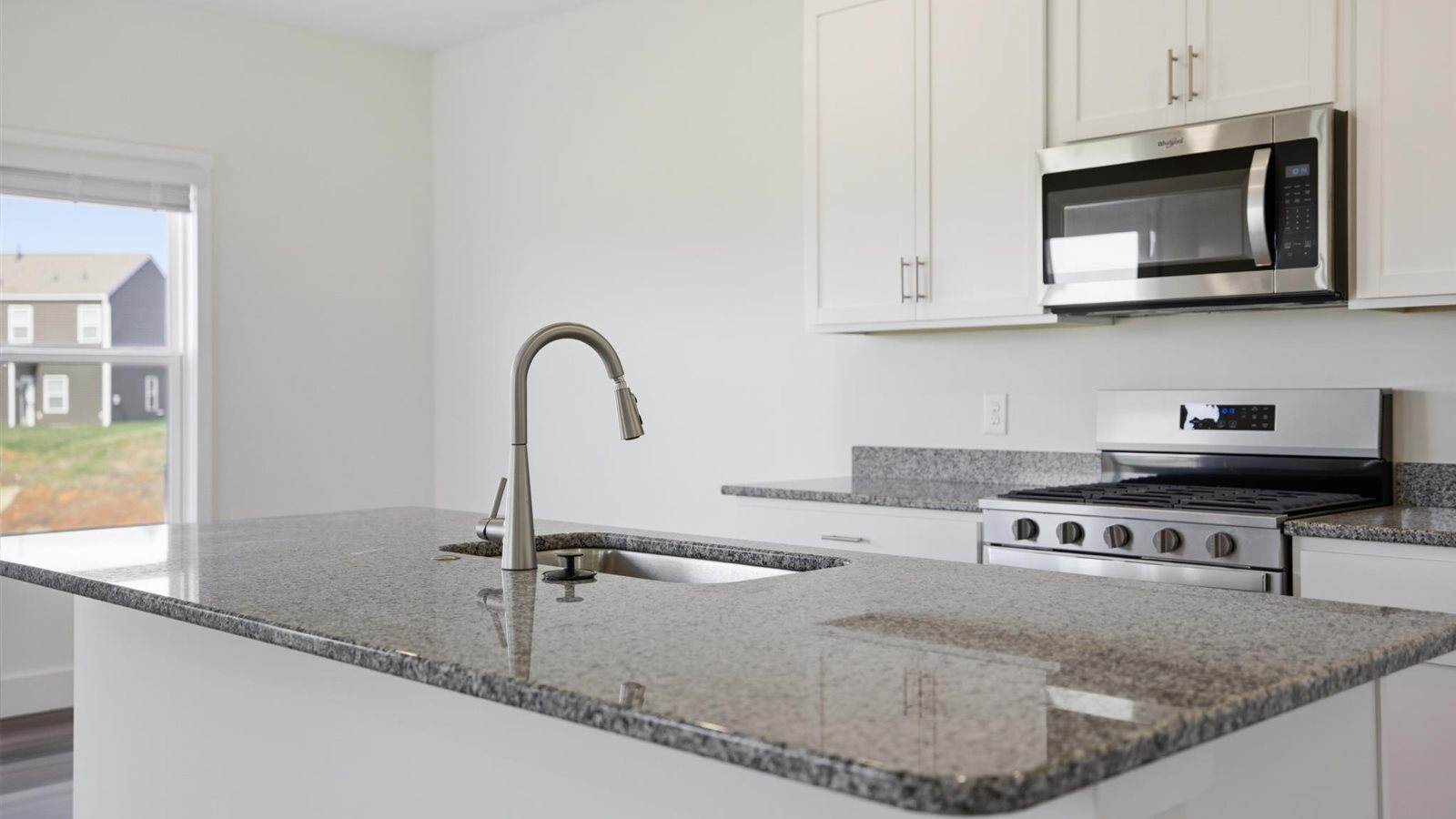 Spacious open concept kitchen with island and counter prep space