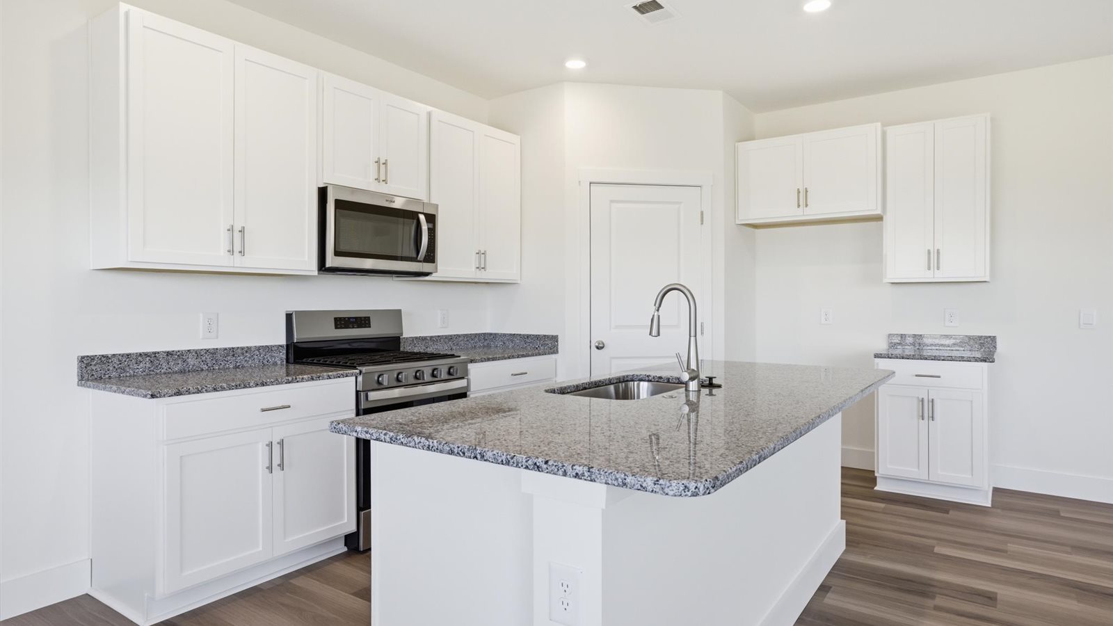 Spacious open concept kitchen with island and counter prep space