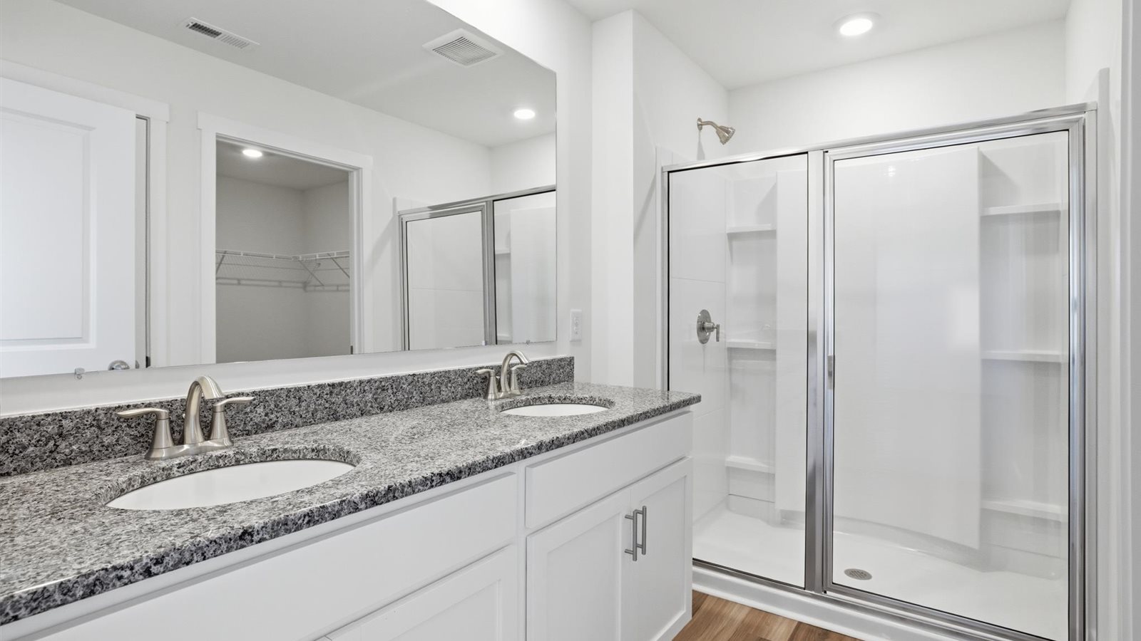 Primary bathroom with double vanity and walk-in shower