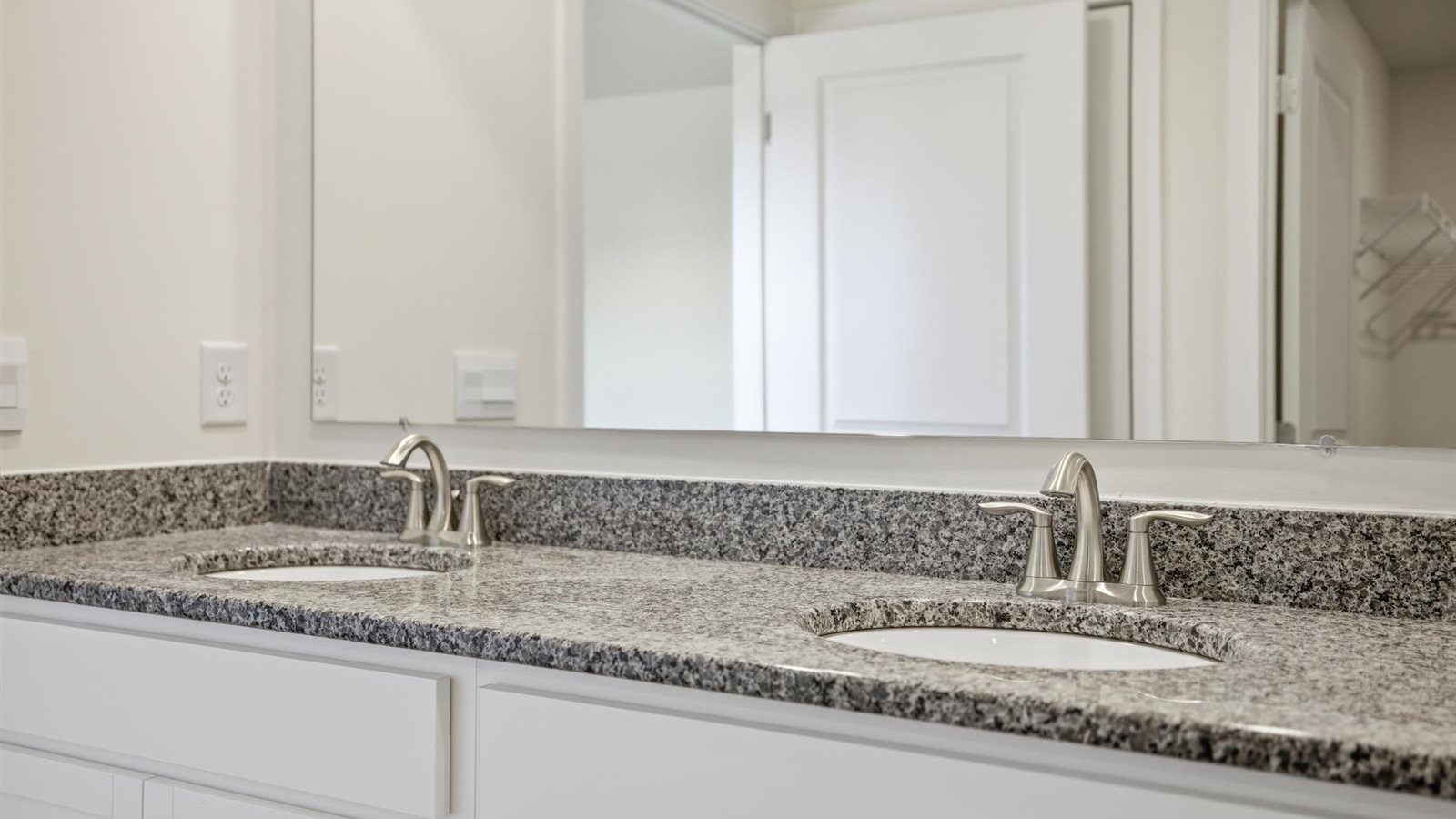 Primary bathroom with double vanity and walk-in shower