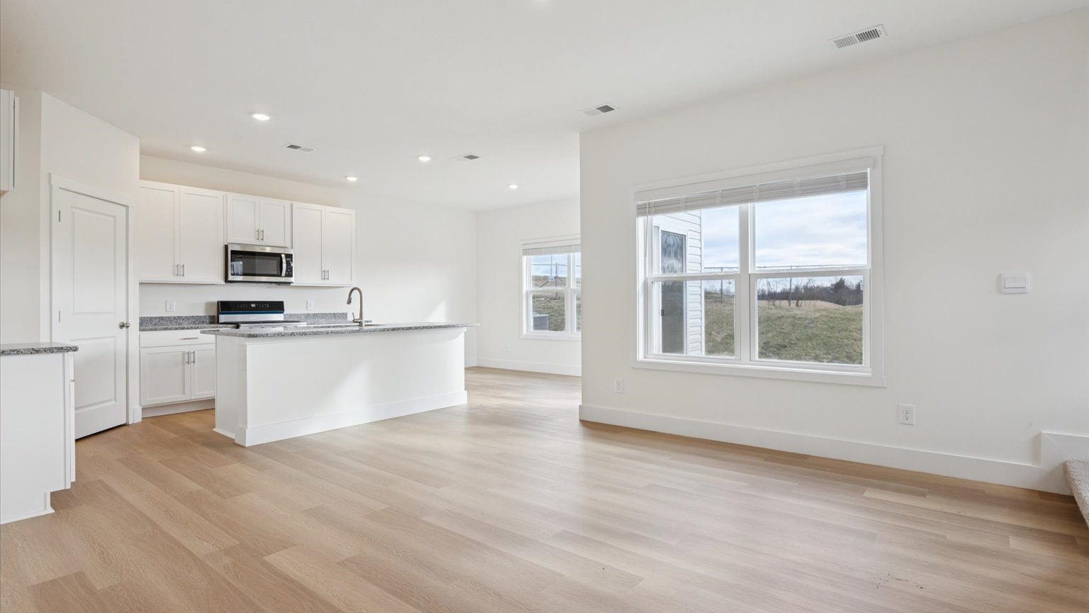 Open concept living, dining, and kitchen space