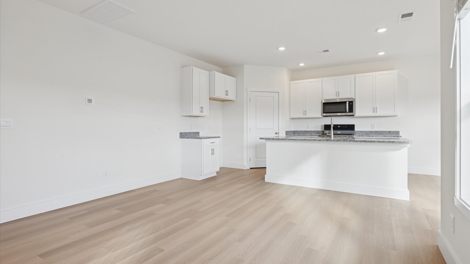 Open concept living, dining, and kitchen space