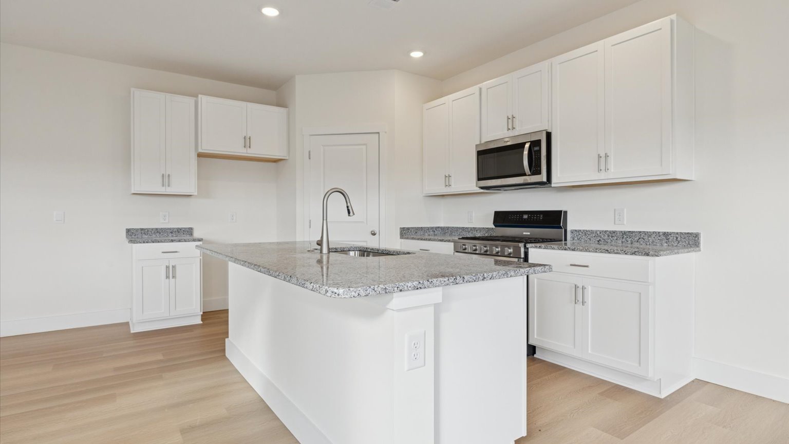 Spacious open concept kitchen with island and counter prep space