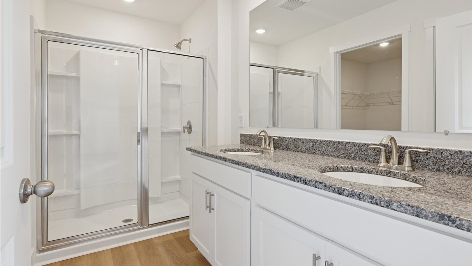 Primary bathroom with double vanity and walk-in shower