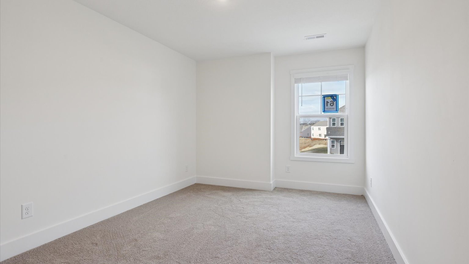 Bedroom with ample natural light and carpet floors