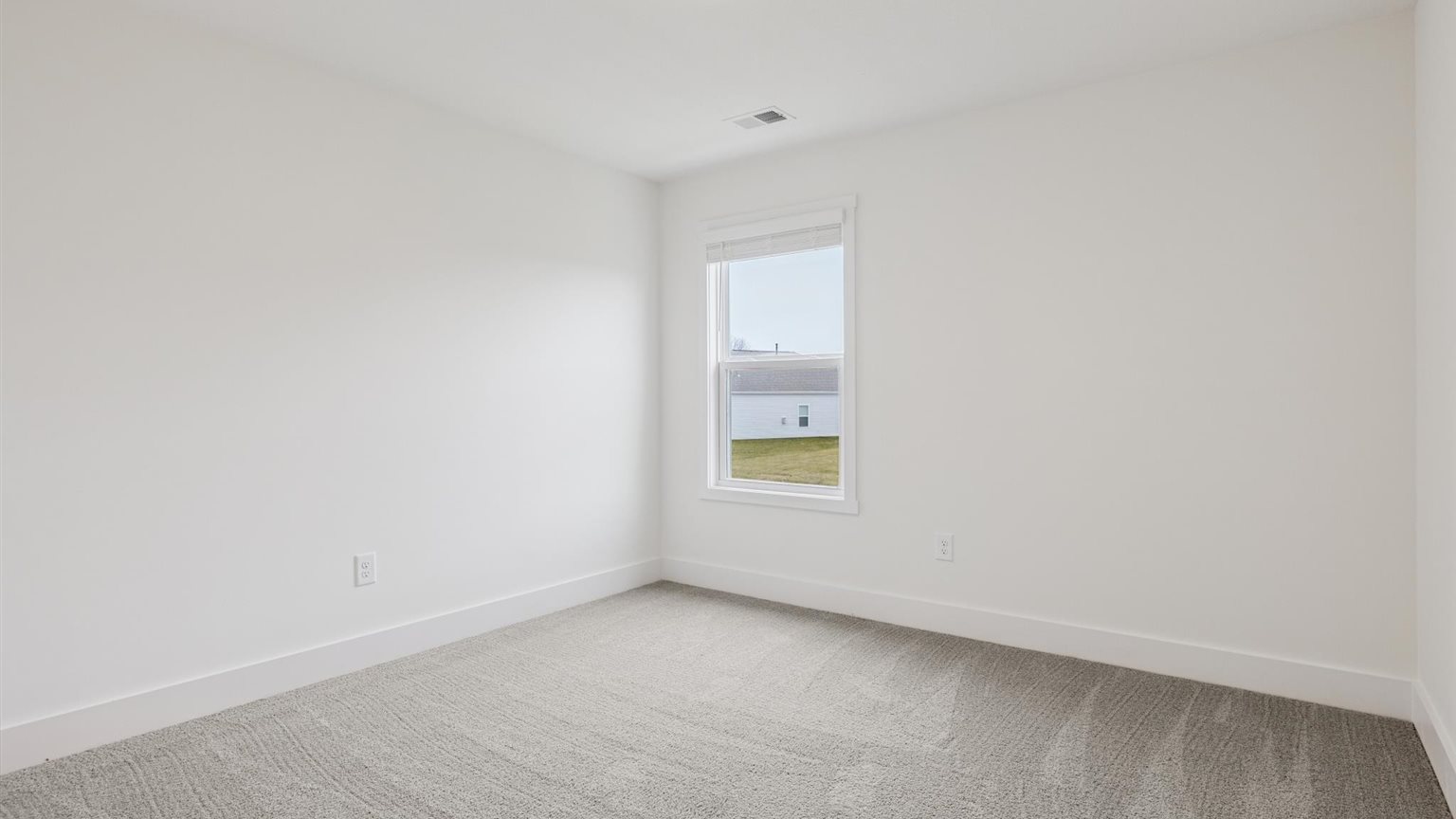 Bedroom with ample natural light and carpet floors