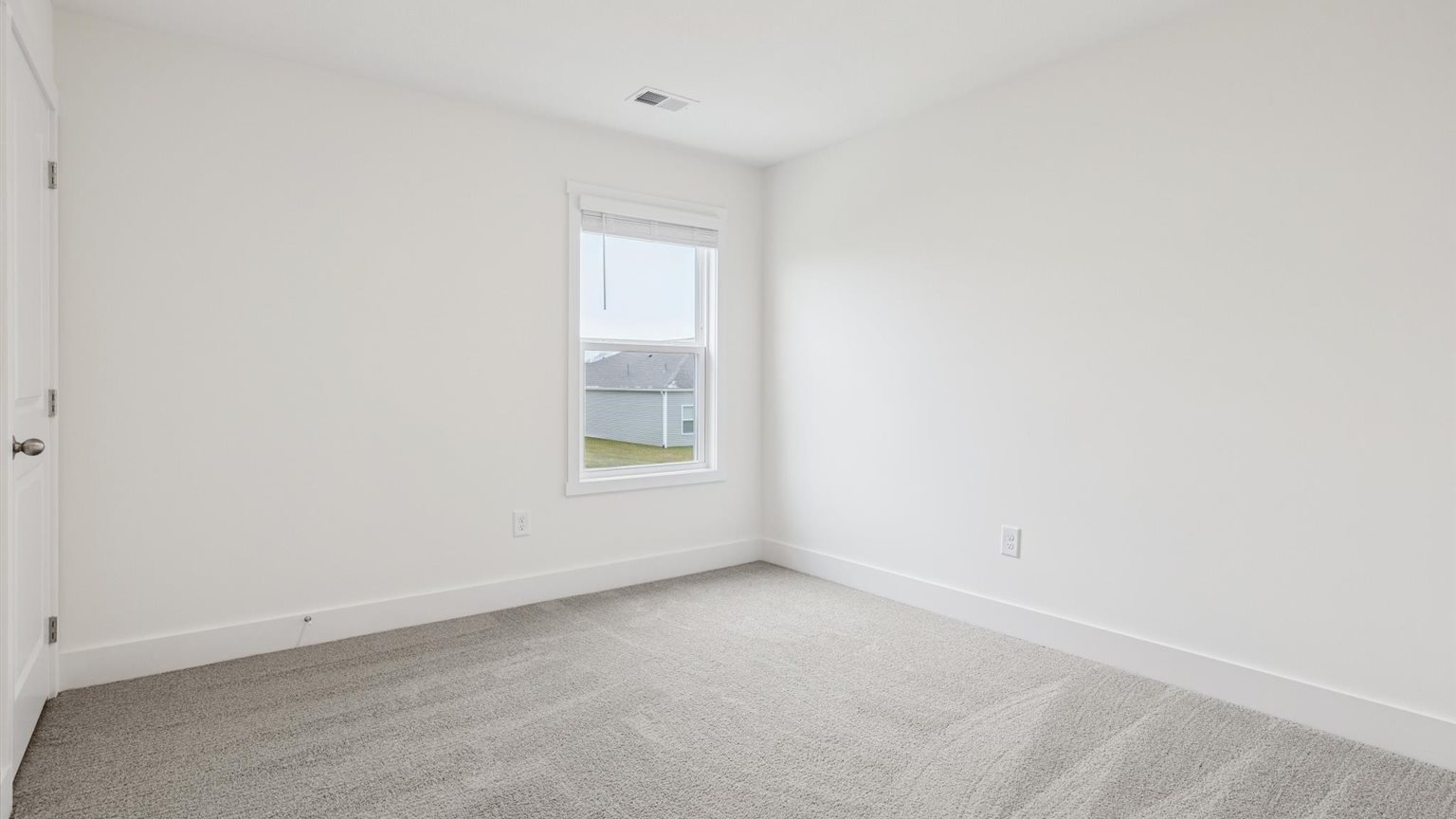 Bedroom with ample natural light and carpet floors