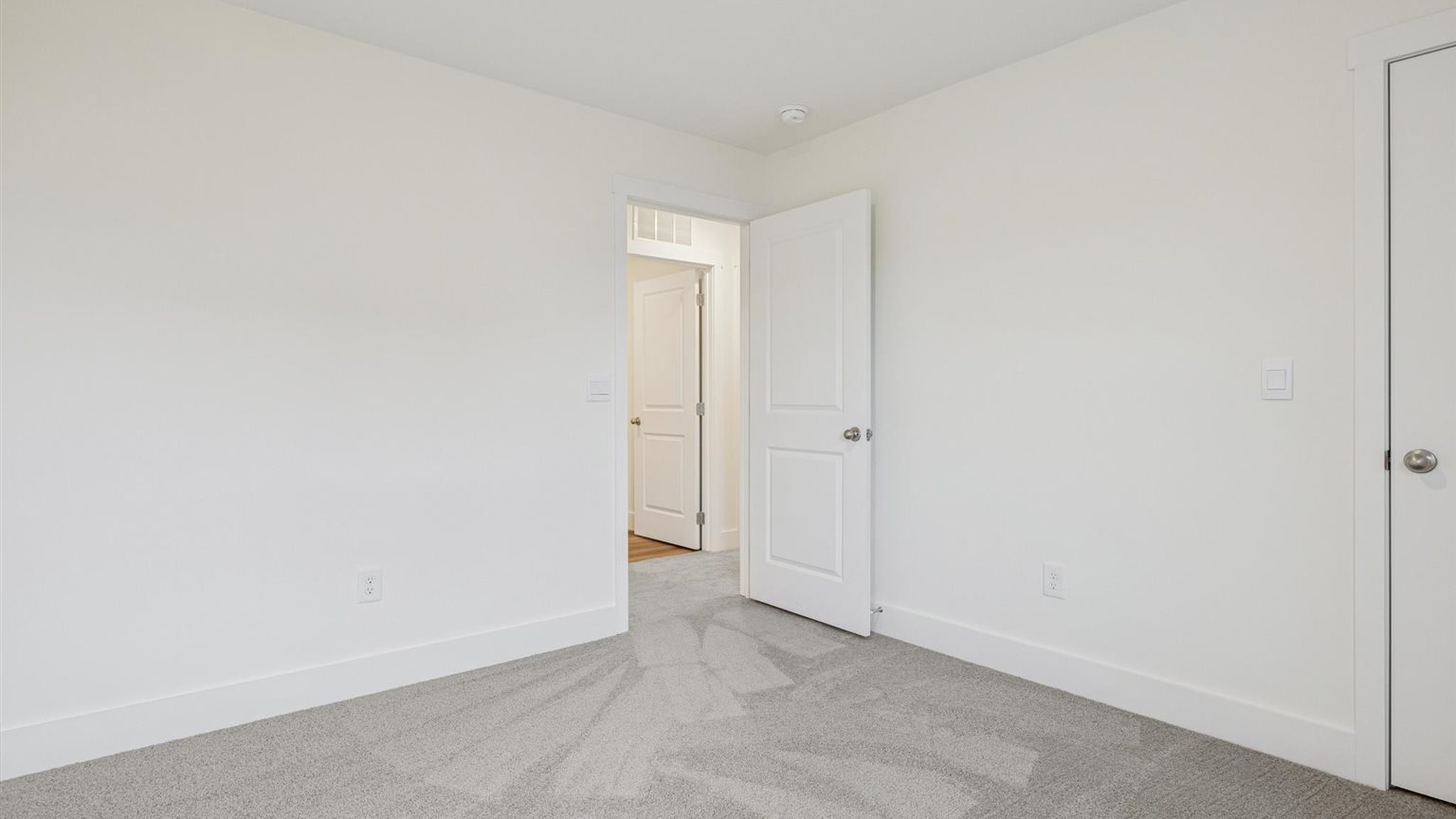 Bedroom with ample natural light and carpet floors