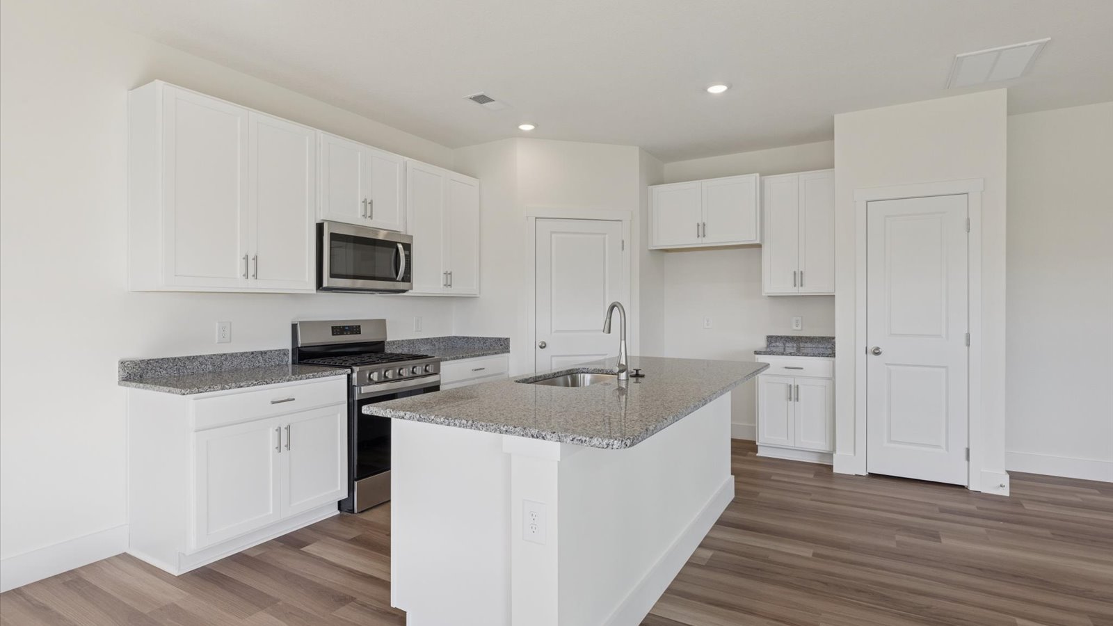 Open concept living, dining, and kitchen space