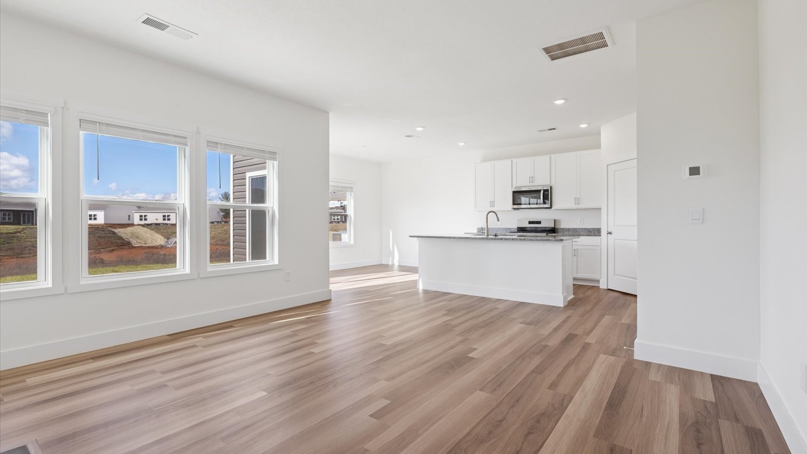 Open concept living, dining, and kitchen space