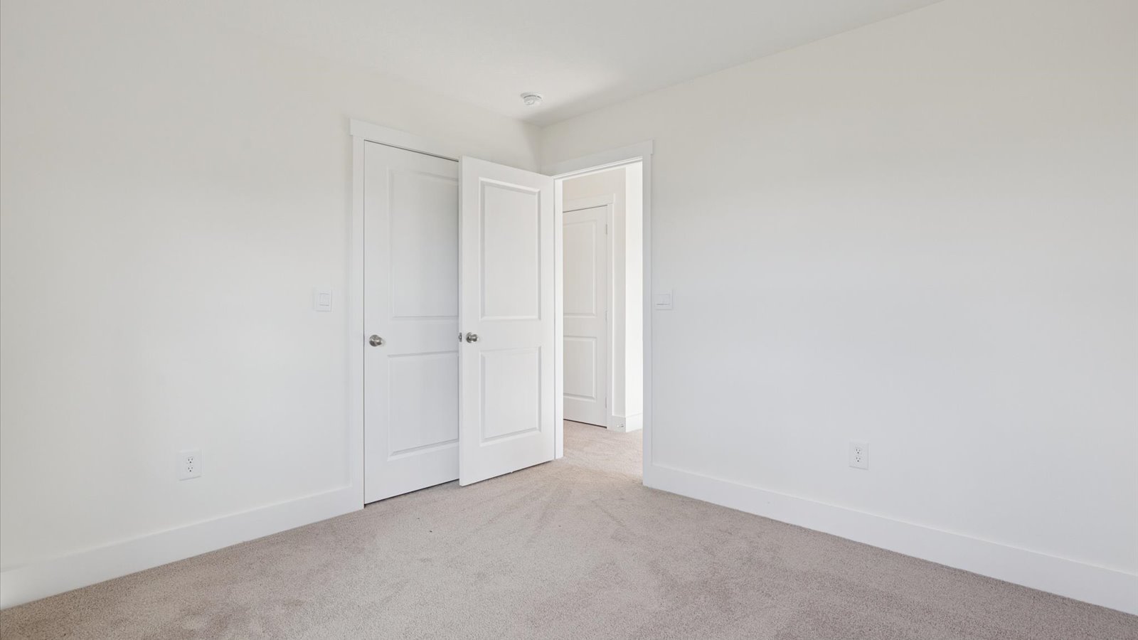 Bedroom with ample natural light and plush carpet floors
