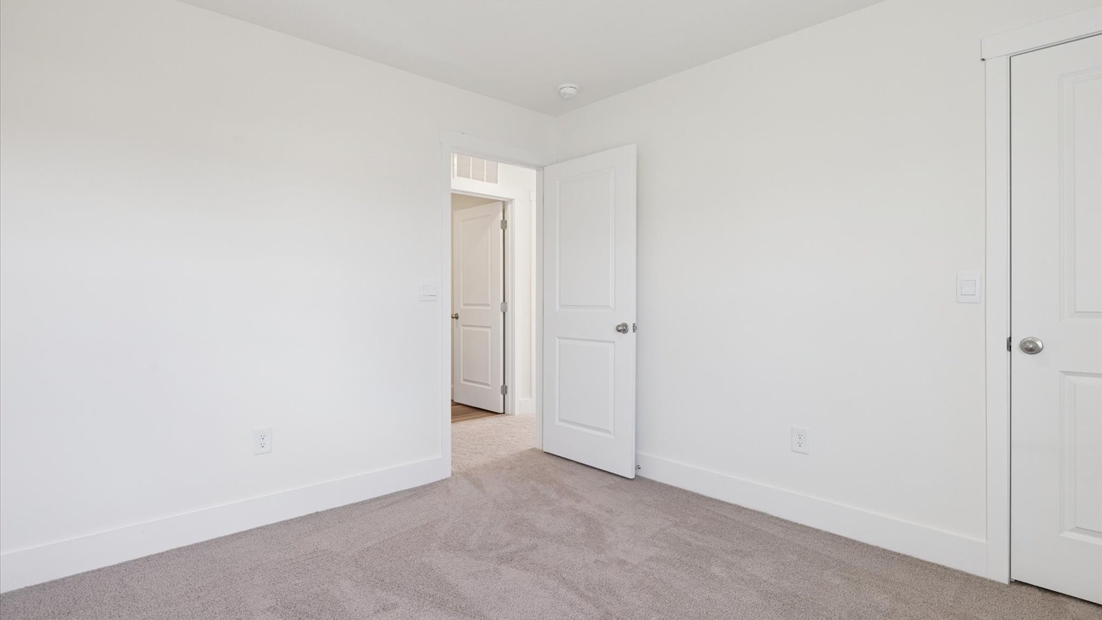 Bedroom with ample natural light and plush carpet floors