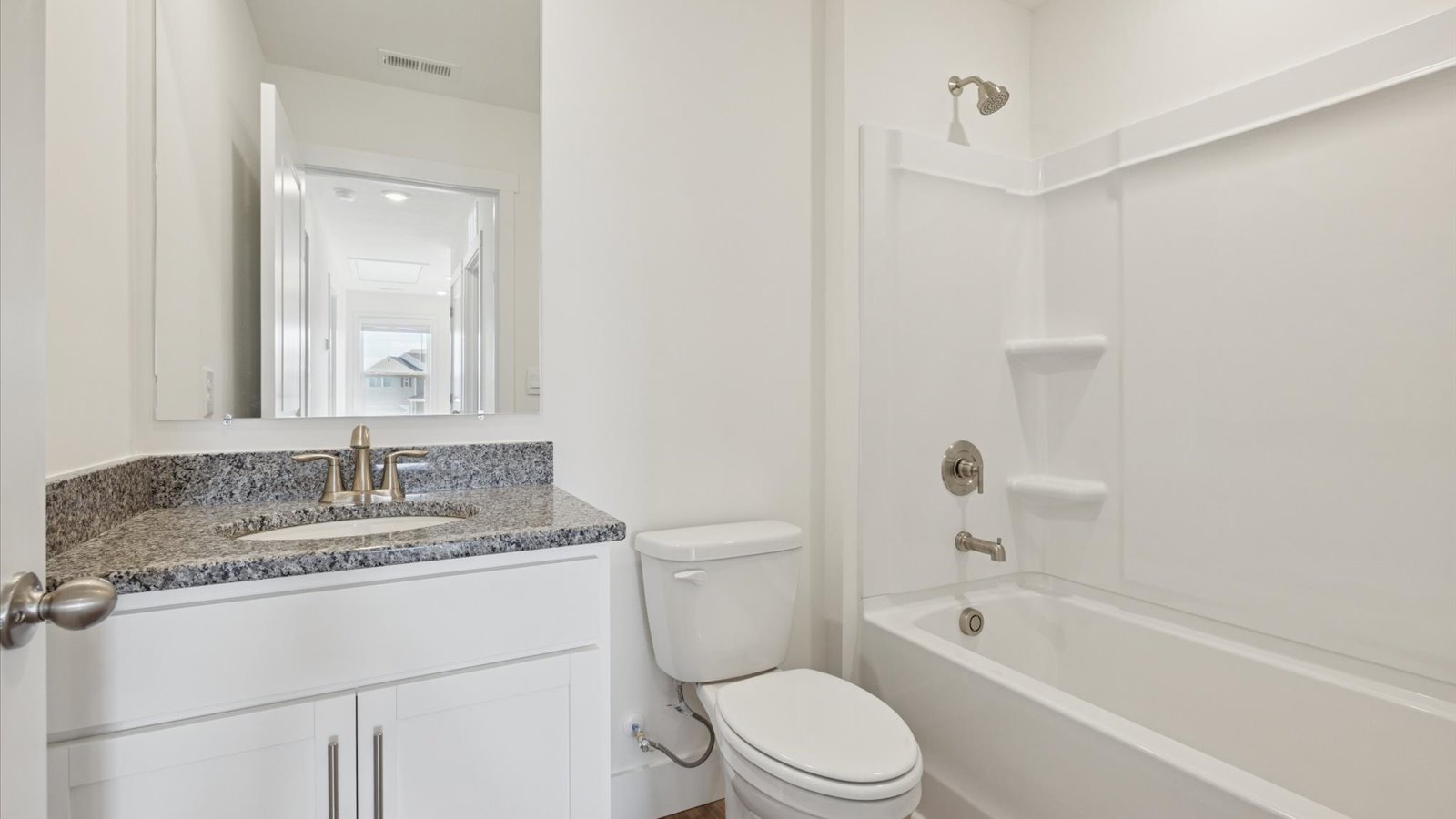 Upstairs guest bathroom with combination shower and bathtub