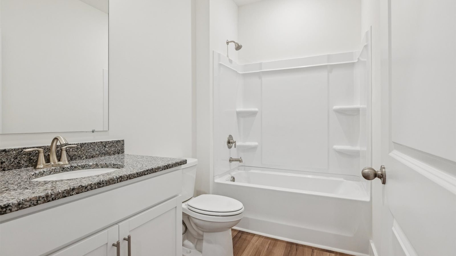 Guest bathroom with built in vanity and combination bathtub shower