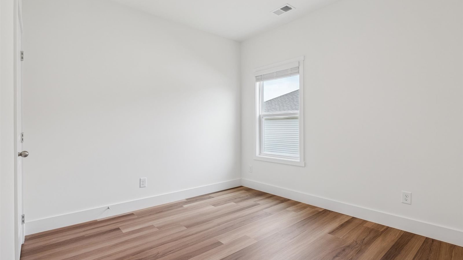 Guest bedroom 1 with front windows and ample natural light