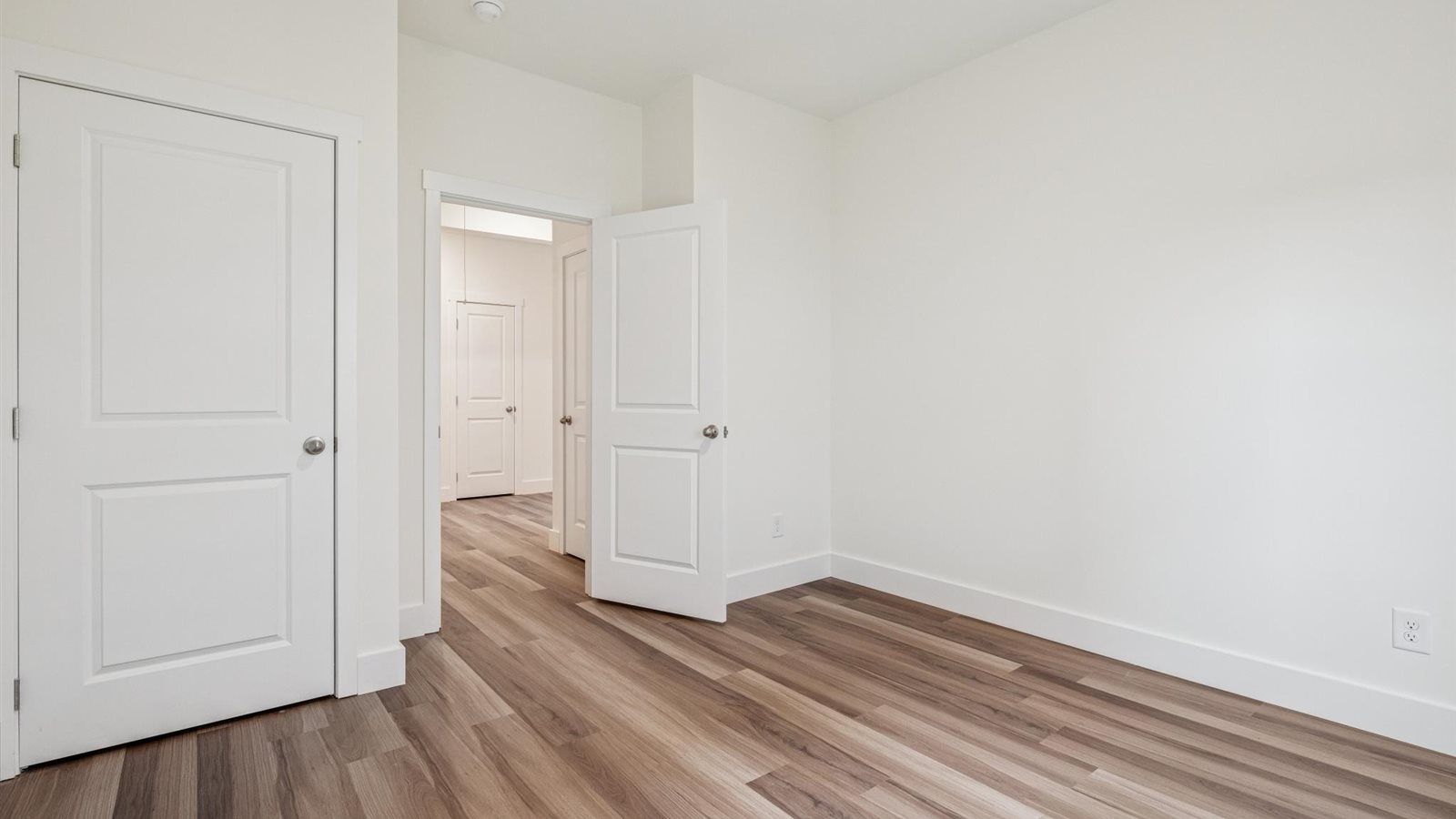 Guest bedroom 1 with front windows and ample natural light