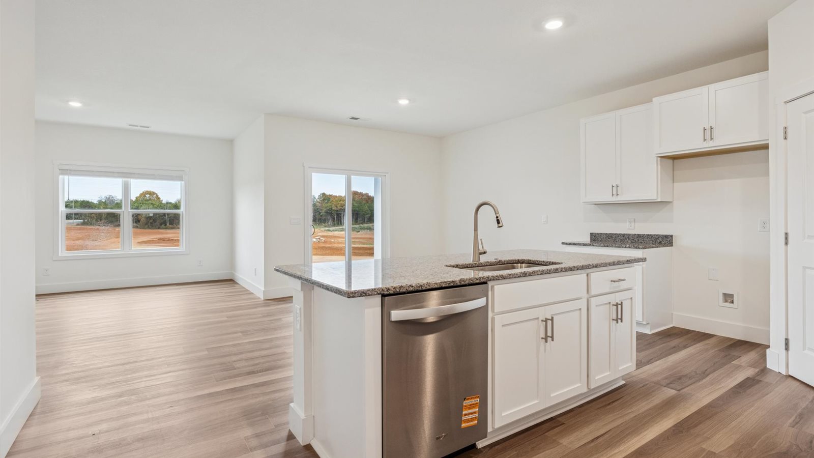 Open concept living, dining, and kitchen space