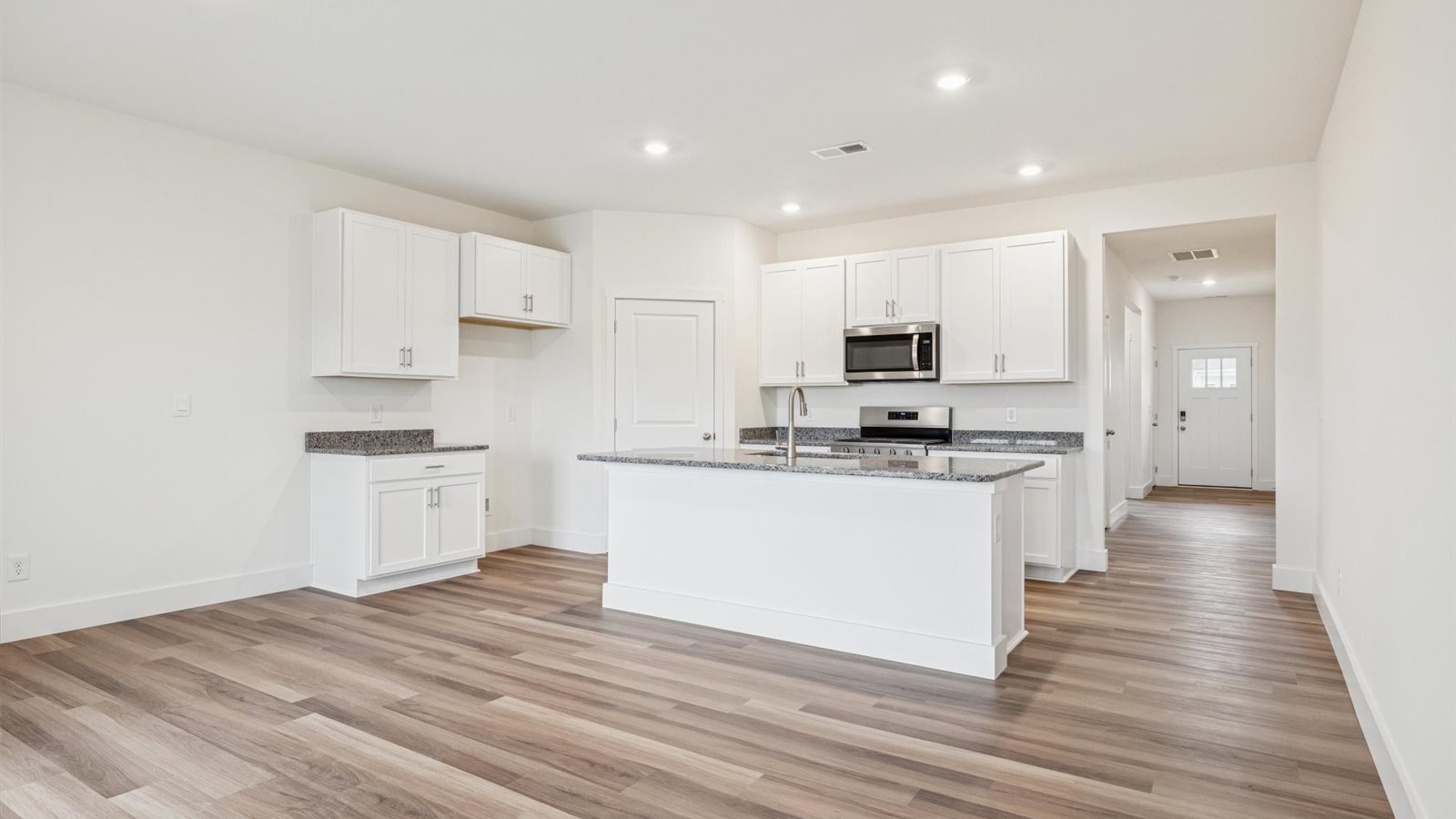 Open concept living, dining, and kitchen space