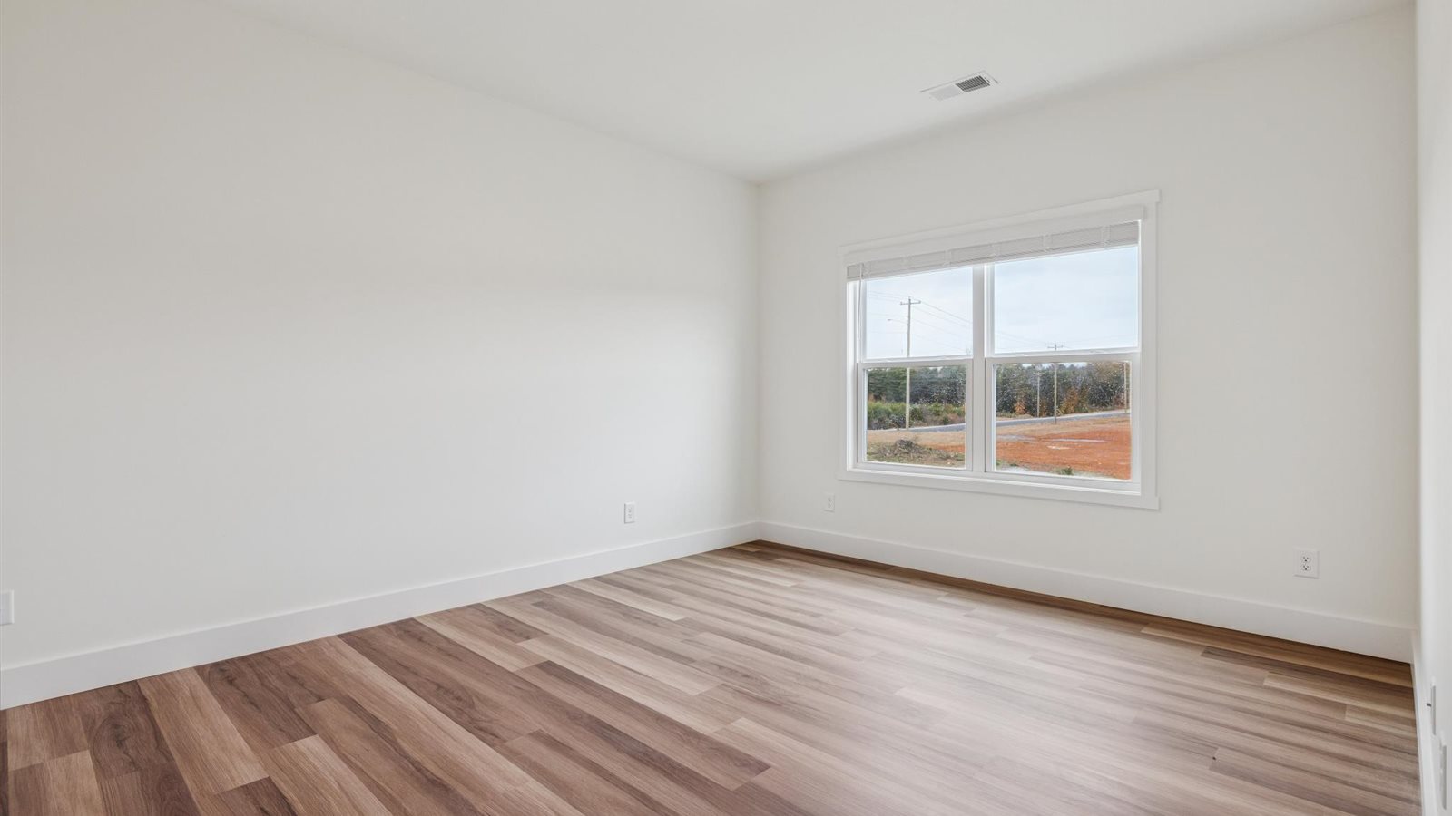 Primary bedroom with private attached bathroom and walk-in closet