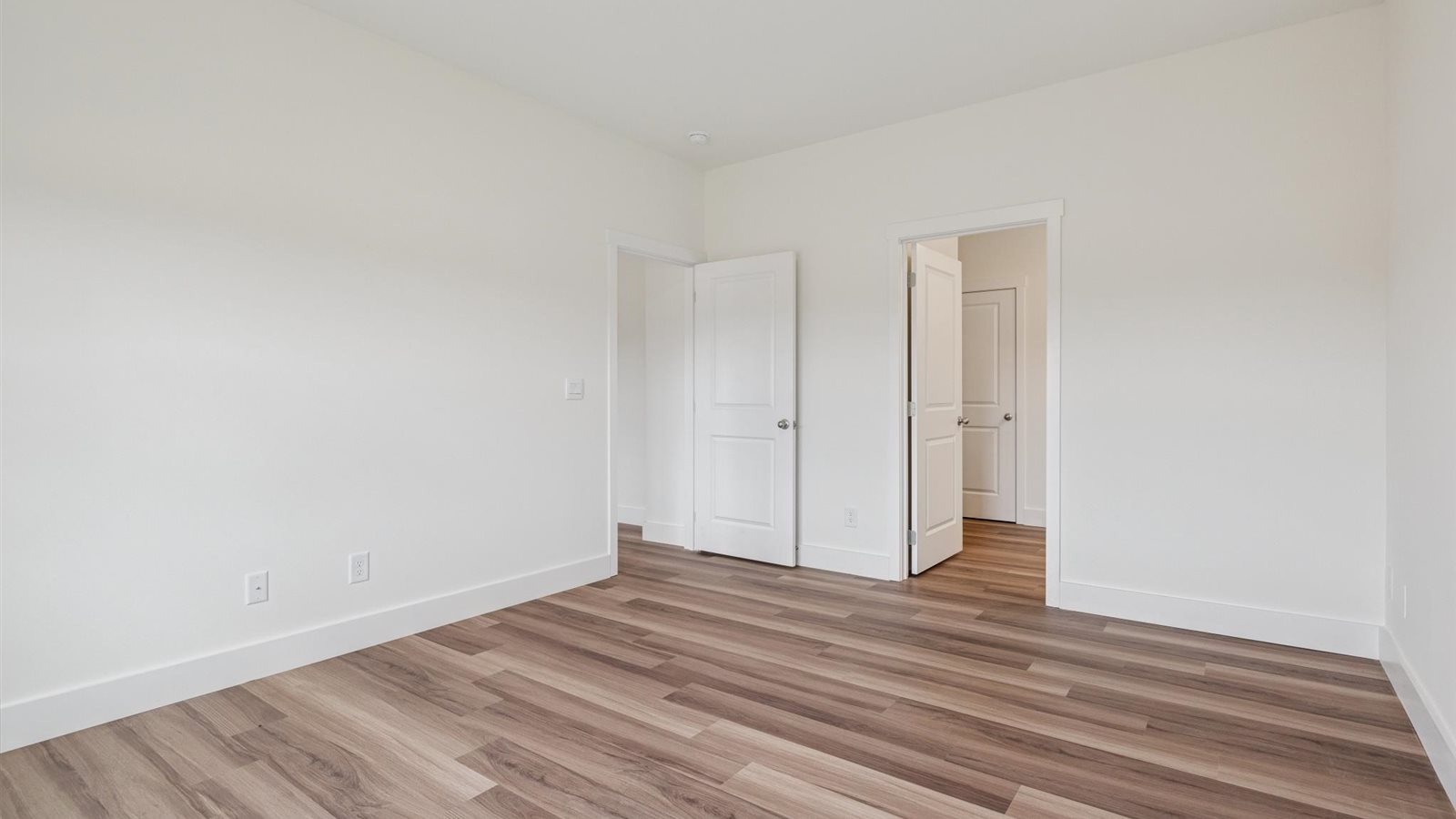 Primary bedroom with private attached bathroom and walk-in closet
