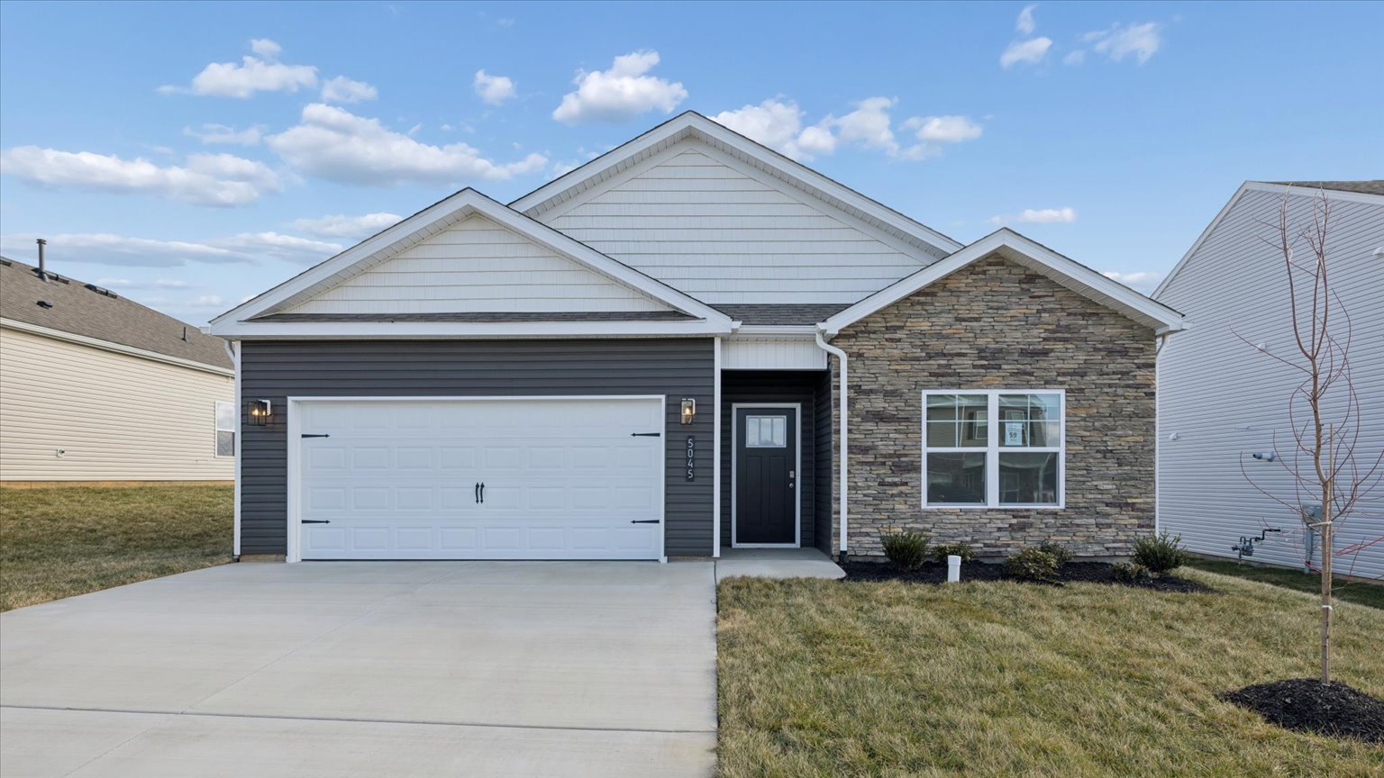 Exterior of single story ranch home with vinyl, shake, and brick