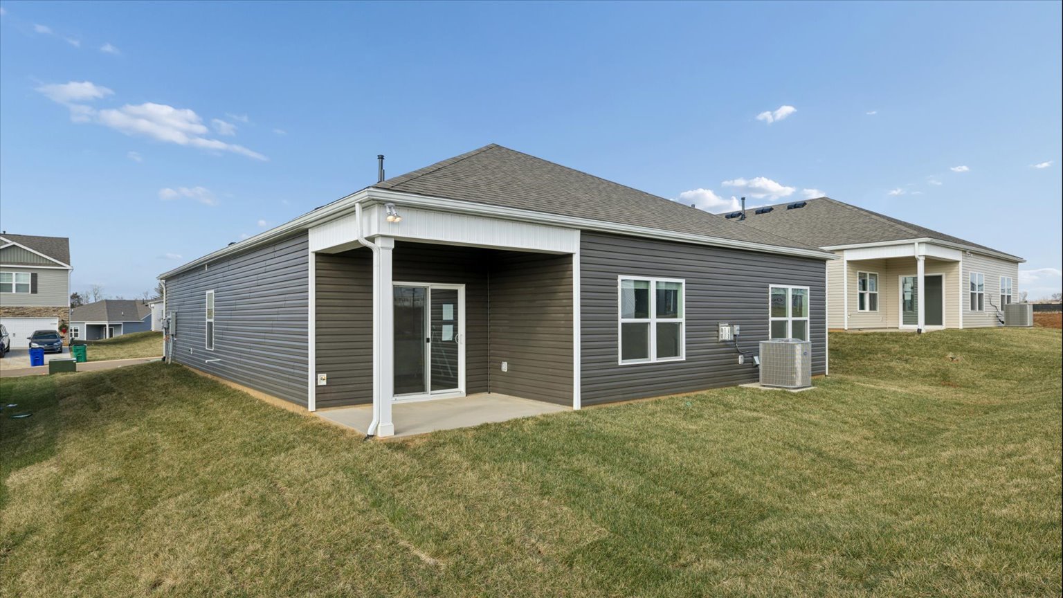 Exterior of single story ranch home with vinyl, shake, and brick