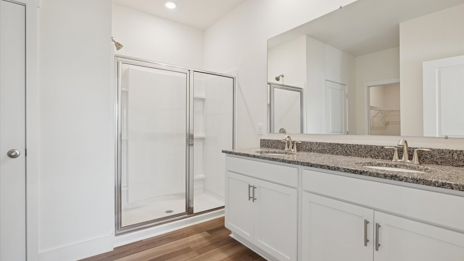 Primary bathroom with double vanity and walk-in shower