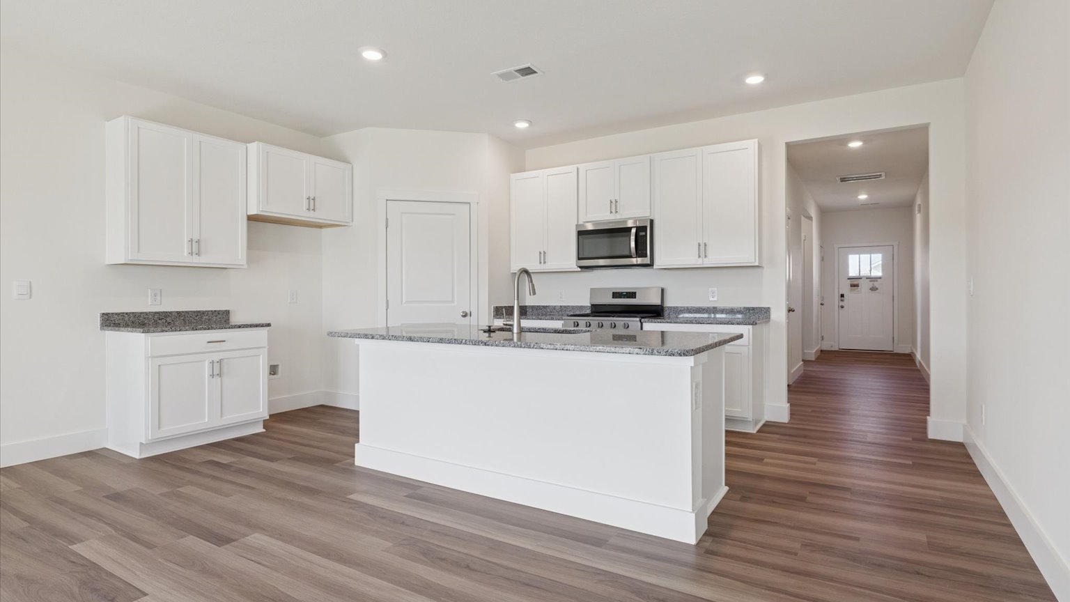 Spacious living and great  room space with light allowing windows