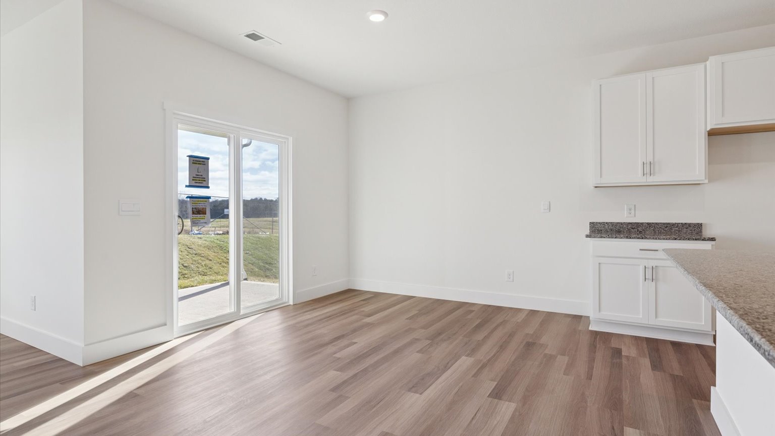 Spacious living and great  room space with light allowing windows