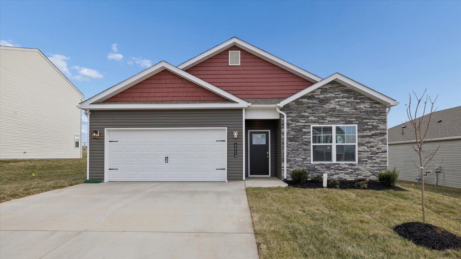 Exterior of single story ranch home with vinyl, shake, and stone