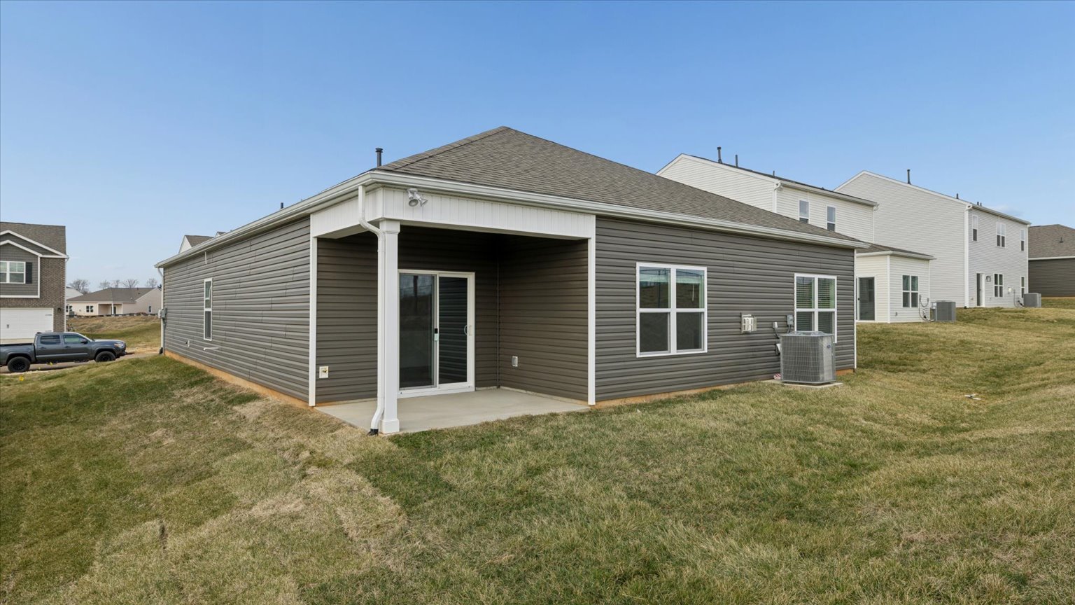 Exterior of single story ranch home with vinyl, shake, and stone
