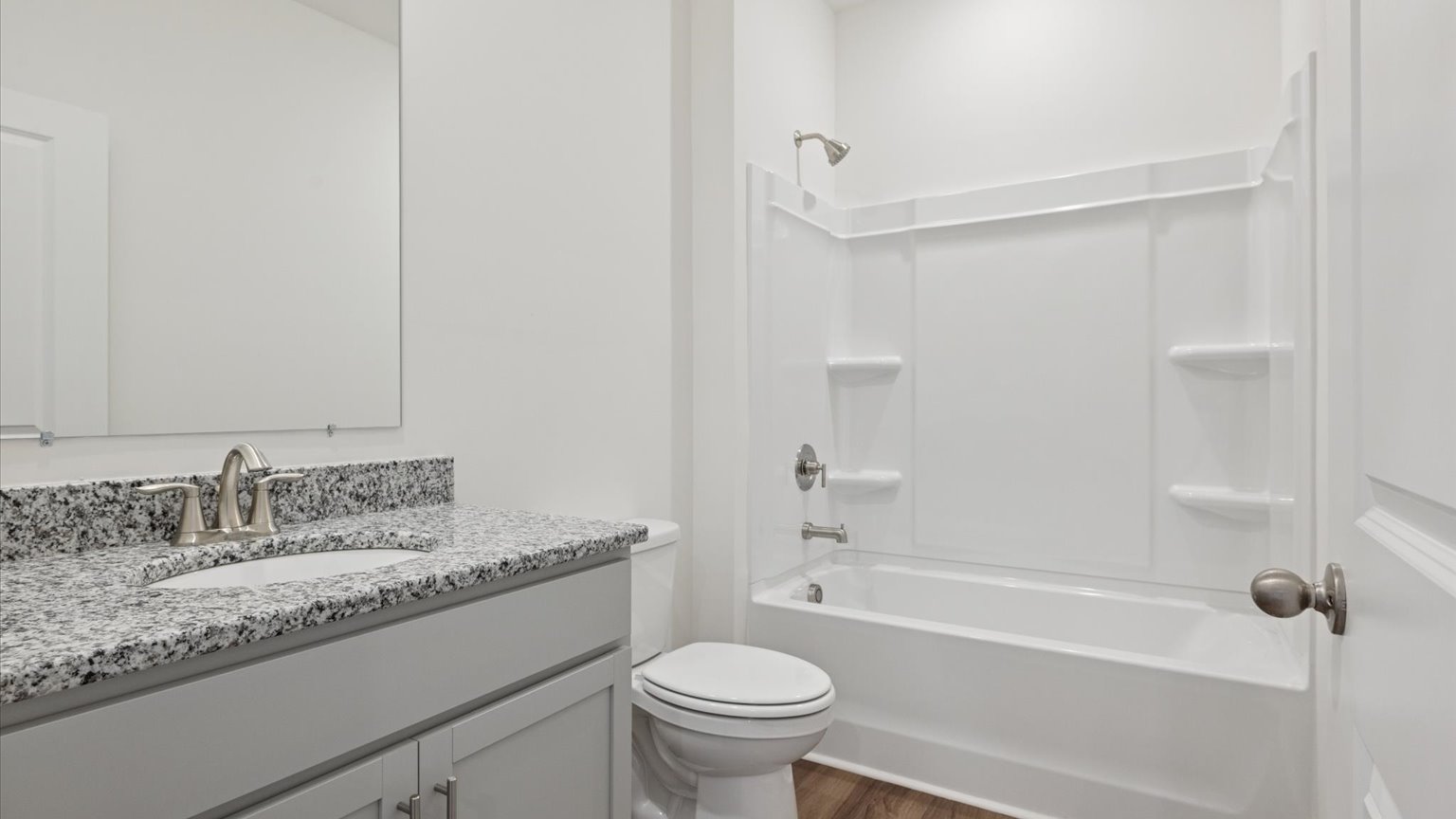 Guest bathroom with built in vanity and combination bathtub shower