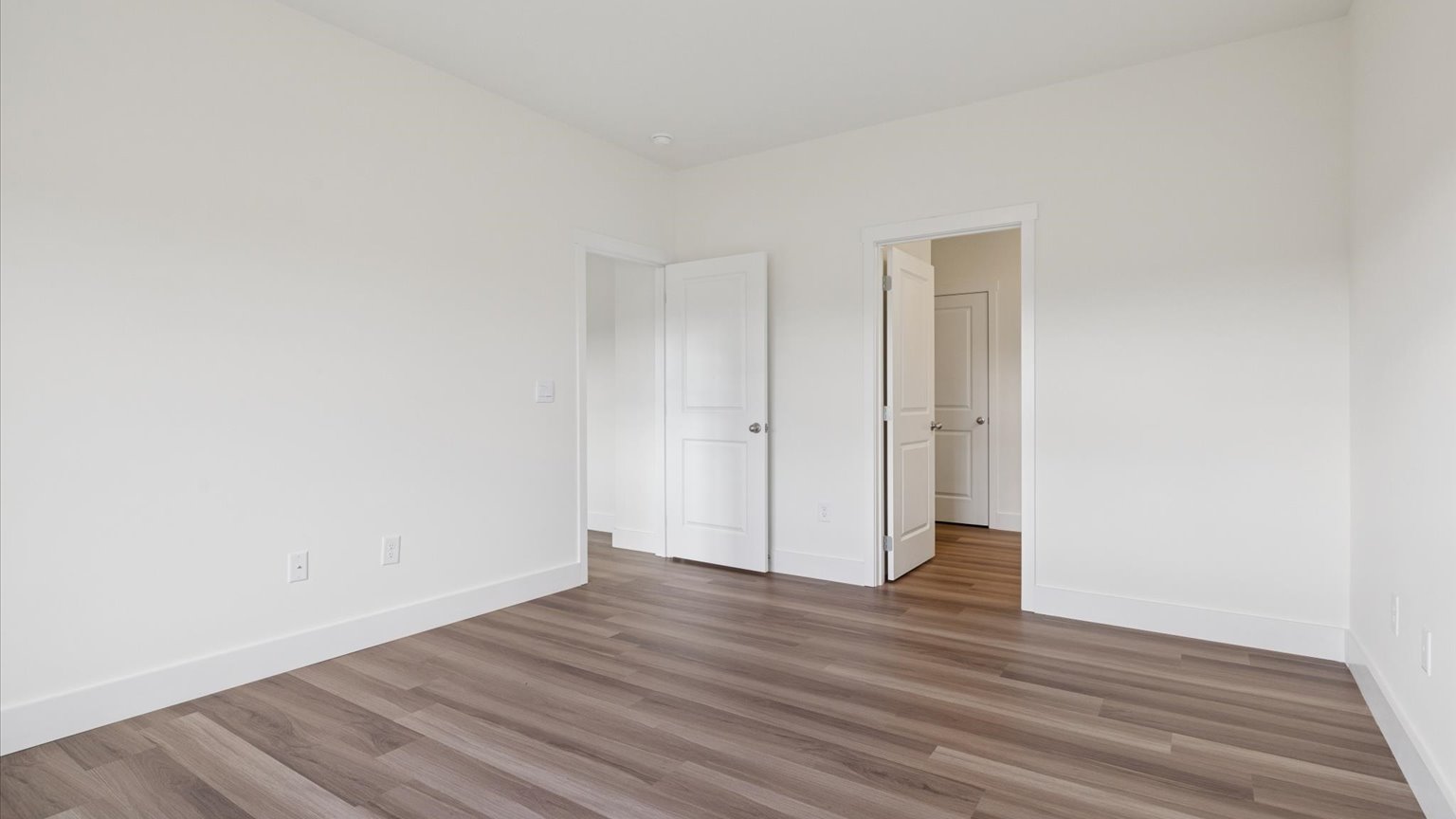 Primary bedroom with private attached bathroom and walk-in closet