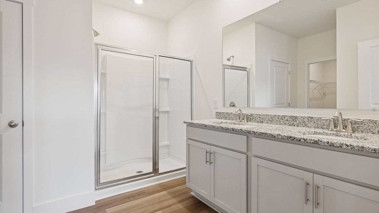 Primary bathroom with double vanity and walk-in shower