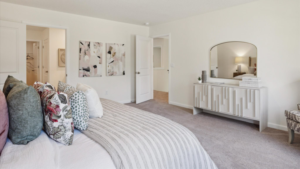 Primary bedroom with private attached bathroom and walk-in closet