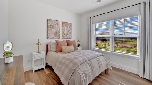 bedroom with a large window, bed and white night stand