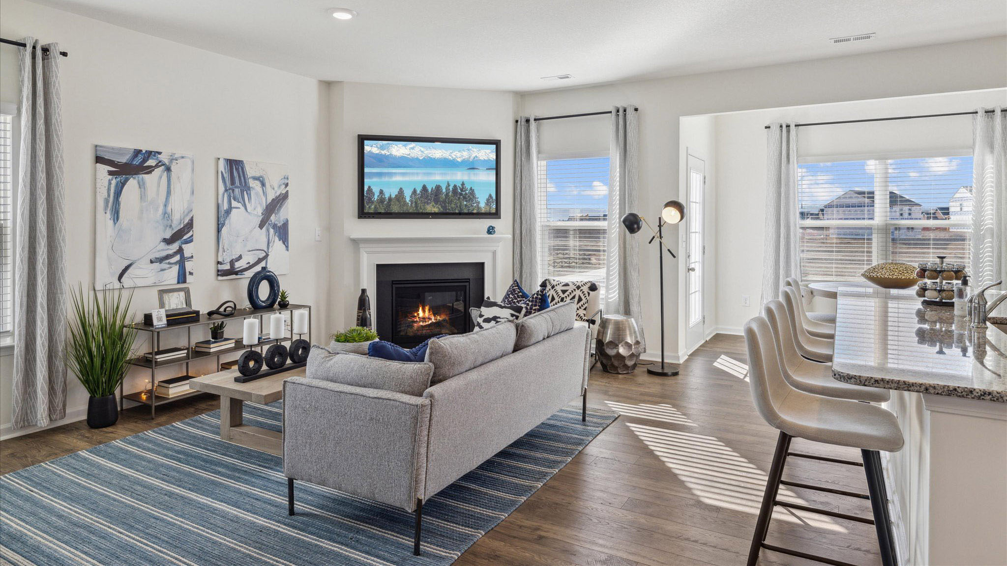 Open concept living area and kitchen with a fireplace.