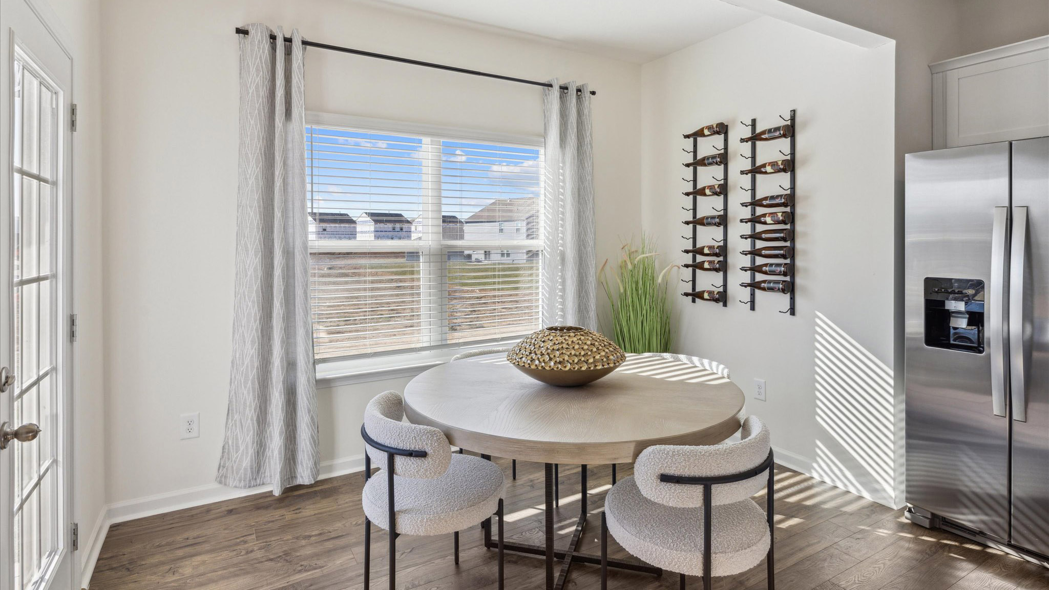 Dining area with a window, tiled floors, and a back door.