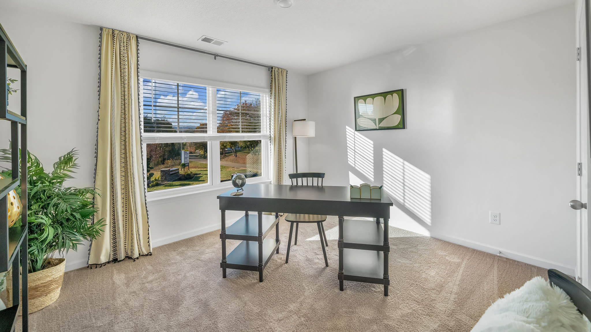 Bedroom with ample natural light and carpet floors