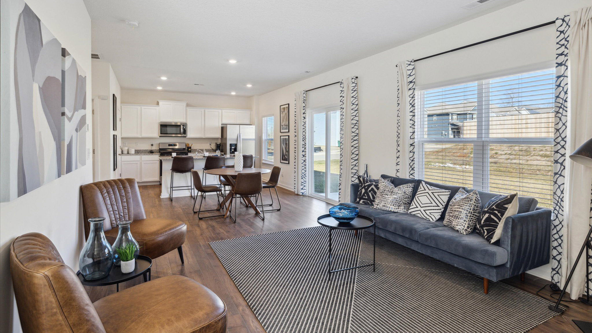 Spacious living and great  room space with light allowing windows