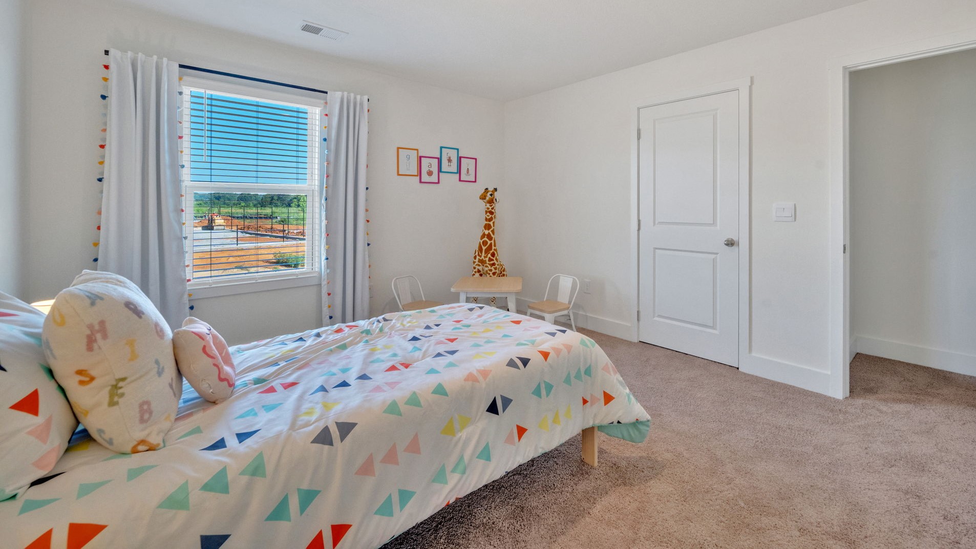 Bedroom with ample natural light and carpet floors
