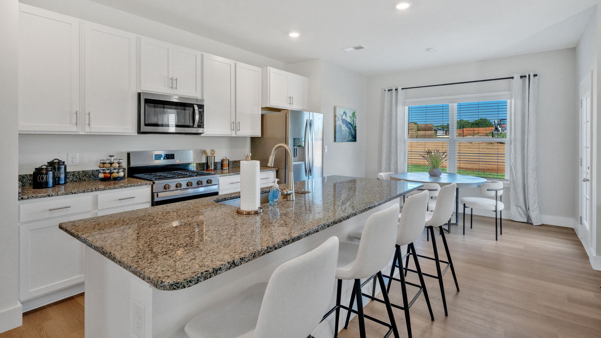 Open concept living, dining, and kitchen space